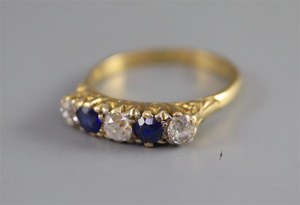 An early/mid 20th century 18ct gold and platinum, two stone sapphire and three stone diamond half hoop ring,